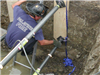 Firefighter sets pneumatic shoring during a trench rescue drill.